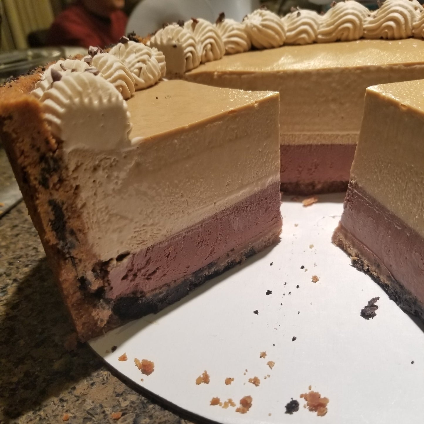Cappuccino Cheesecake sliced showing two cheesecake layers, coffee and chocolate.