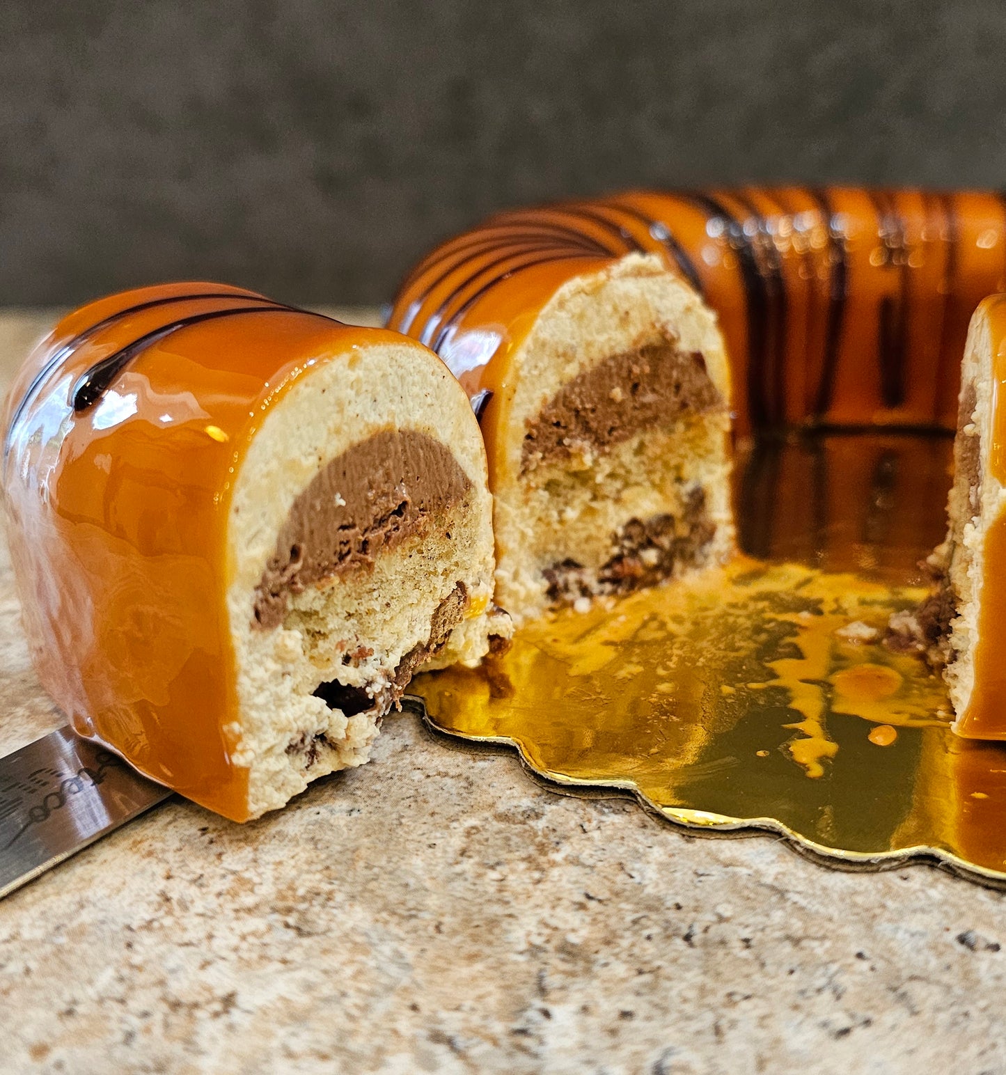 Hazelnut Mousse Cake sliced showing the different layers in the center.