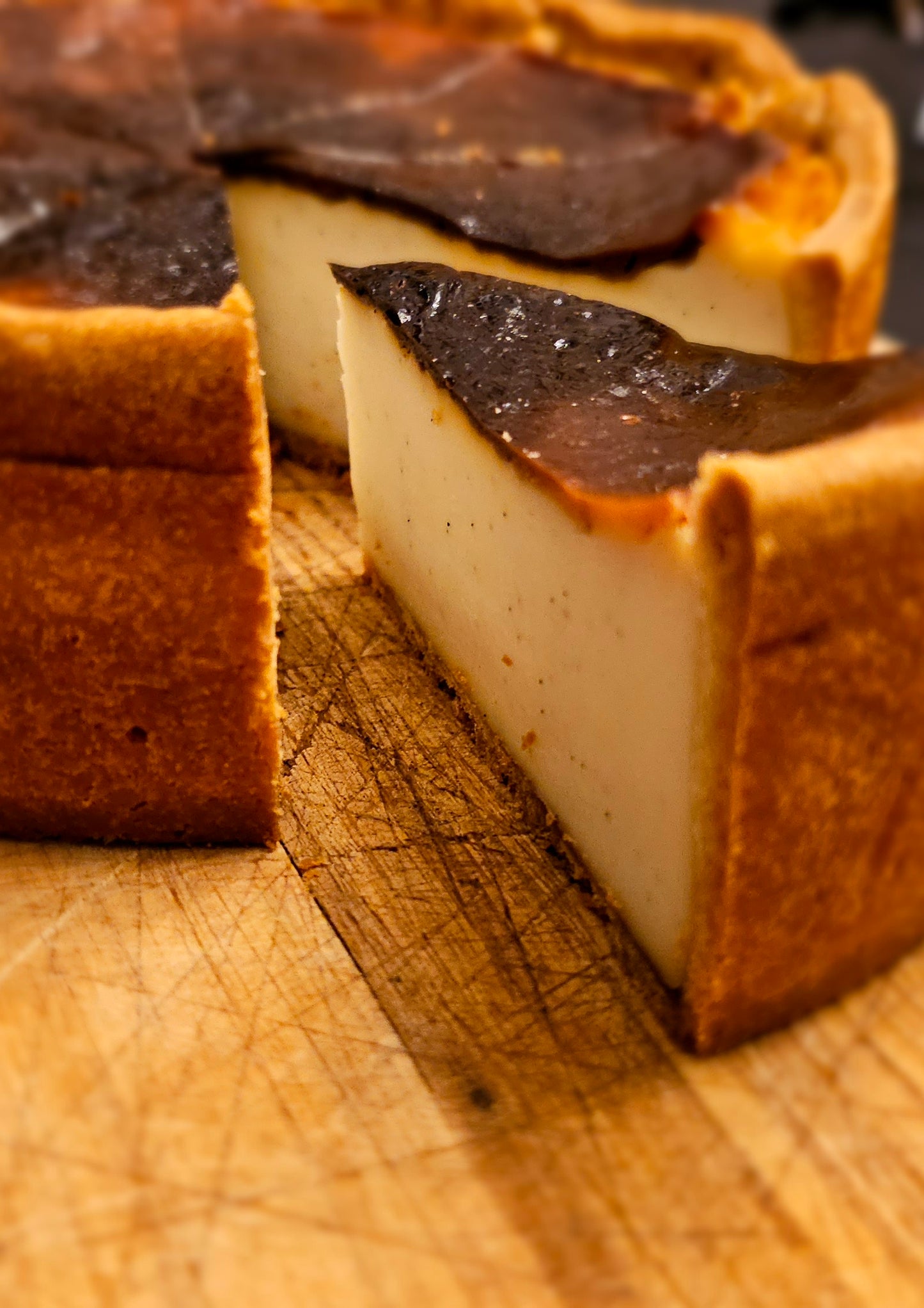 close up of Parisian Flan sliced into wedges with one slice pulled out.