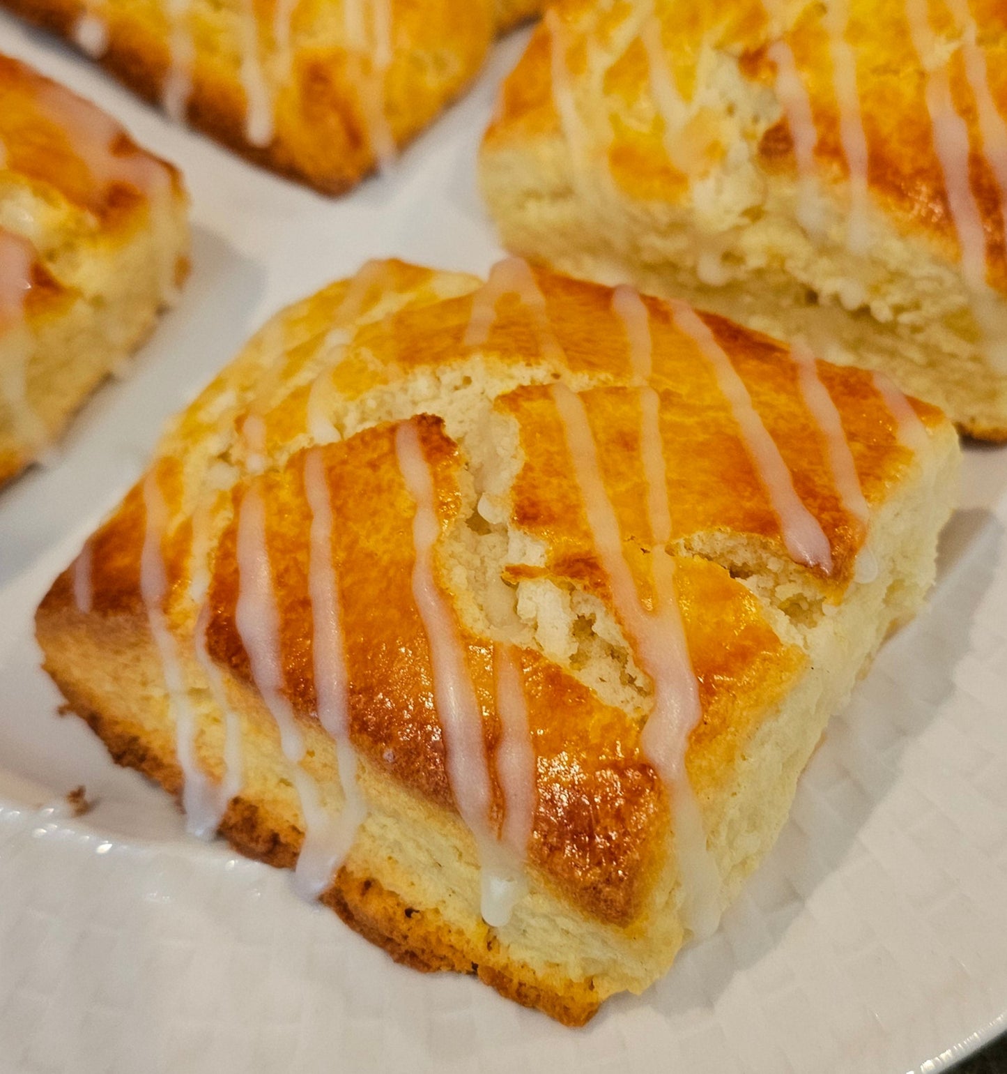 Square scones with glaze on a white plate