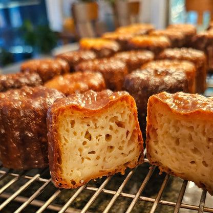 Several canale lined up. One has been cut in half to show the soft center.