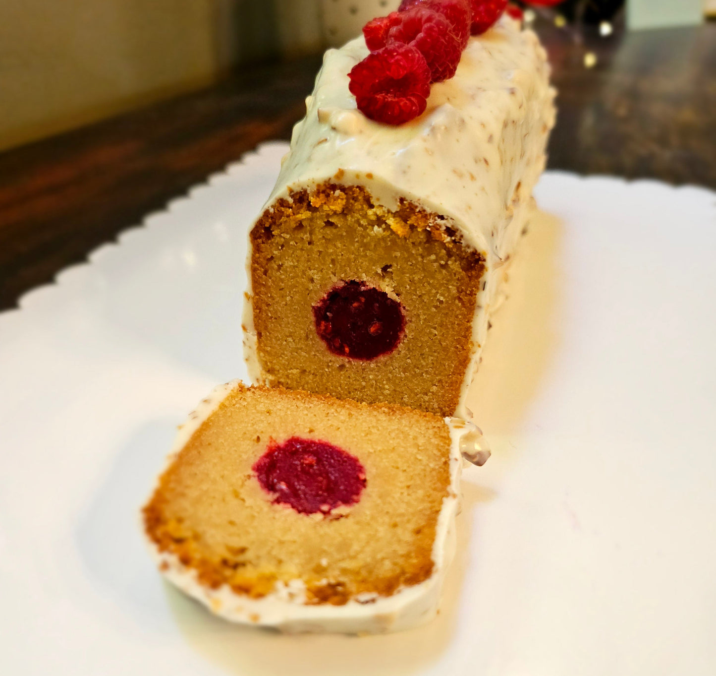 Slice of cake with raspberry filling on a decorative plate