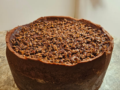 A chocolate flan topped with candied cocoa nibs.