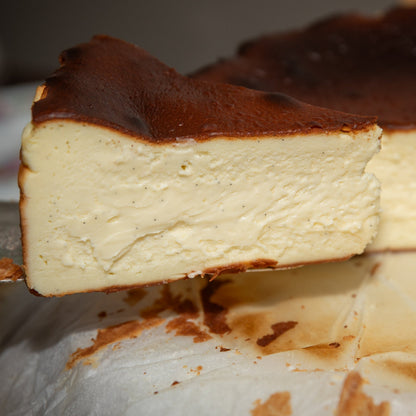 A closeup slice of basque cheesecake showing the creamy interior.