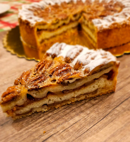 A slice of freshly baked Apple Pecan Charlotte dessert topped with powdered sugar.