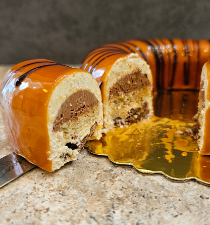 Hazelnut Mousse Cake sliced showing the different layers in the center.