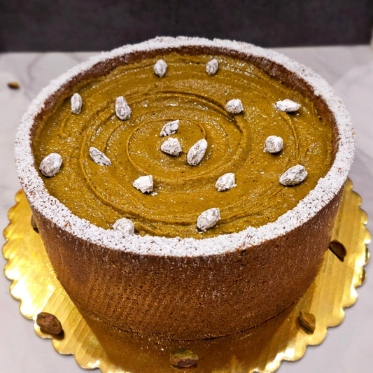 Pistachio Cheesecake decorated with pistachio praline and candied pistachios.