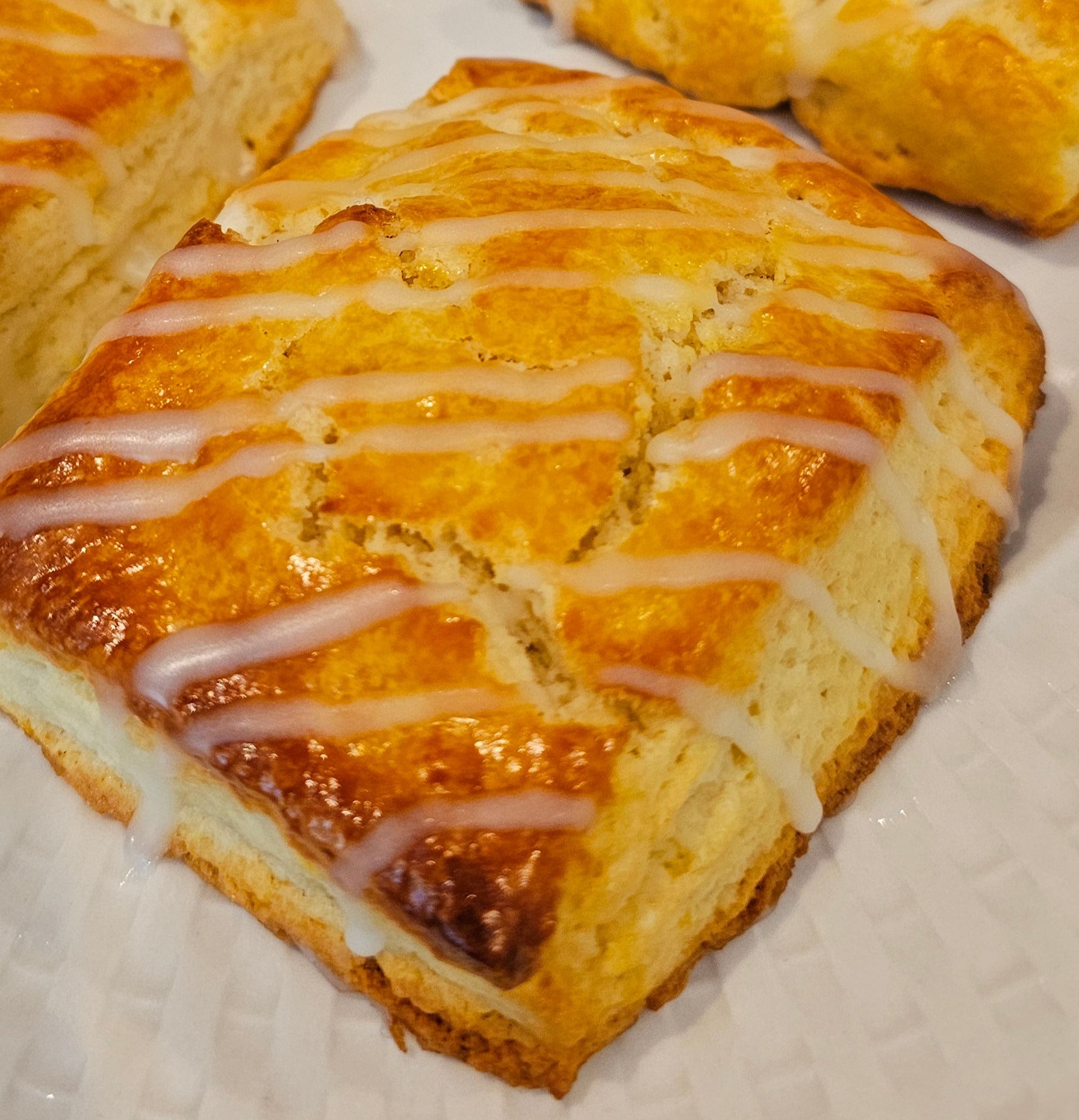 Square scones with glaze on a white plate