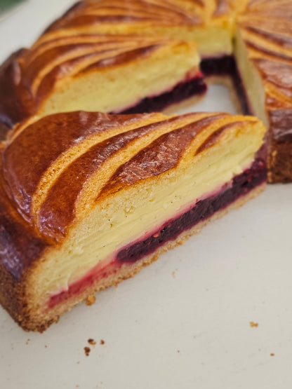 Sliced cake with a visible fruit filling on a white plate